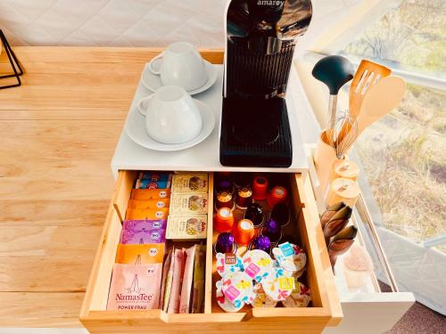 a wooden tray with a tea set on a table at Glamping Hohe Wand - Kuppelzelt mit Whirlpool & Panoramafenster in Maiersdorf