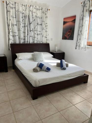 a bed with two pillows on it in a bedroom at Villa Amandine in Peyia