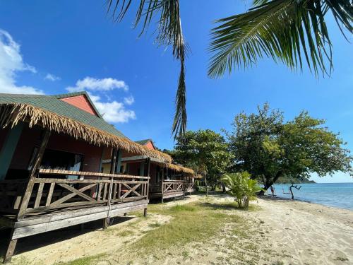 a building on the beach next to the ocean at Kai Bae Beach Resort Koh Chang in Ko Chang