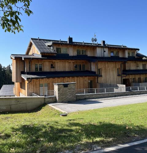 an old wooden building on the side of a road at Slunečný apartmán in Cerny Dul