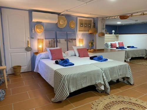 a bedroom with two beds with blue towels on them at 6 Bedroom Luxury Villa, Jacuzzi & heated pool 18 guests in Mutxamel