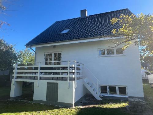 a white house with a staircase on the side of it at Casa de Rainer Copenhagen Room 9 in Copenhagen
