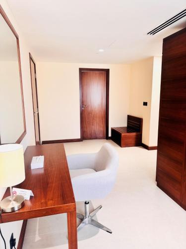 a living room with a white couch and a table at Kyriad Hotel Salalah in Salalah