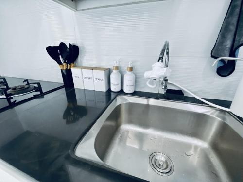 a kitchen counter with a sink and utensils at 10pax 3-Bedroom l Seaview l Georgetown l Gleneagles l Mansion One in George Town