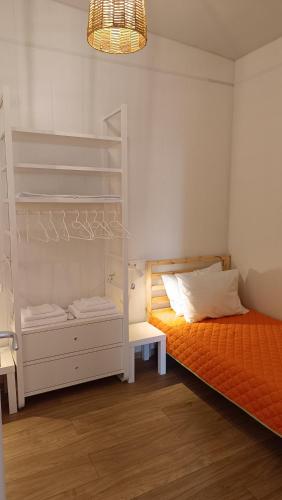 a bedroom with a bunk bed and an orange mattress at Sunlite Summer Cottages in Obzor