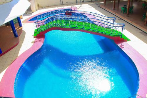 an overhead view of a water slide in a swimming pool at New Green Horse Hotel in Cotonou