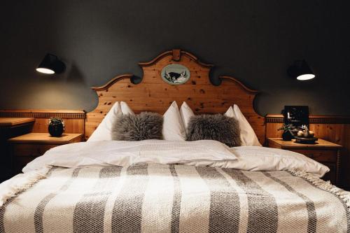 a bedroom with a bed with two stuffed animals on it at Designhotel Sonnhof by Vitus Winkler in Sankt Veit im Pongau