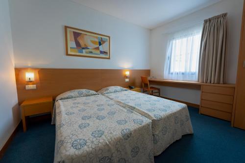 Postel nebo postele na pokoji v ubytování Hotel Matriz