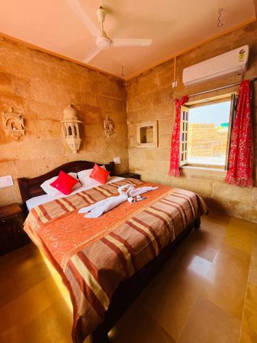 a bedroom with a large bed in a room at Mud Mirror Guesthouse in Jaisalmer