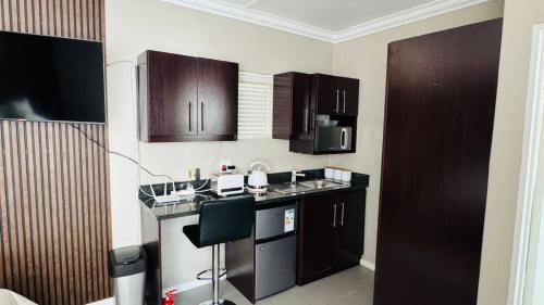 a kitchen with wooden cabinets and a counter top at 110 Berry Street Self-Catering Accommodation in Queenstown