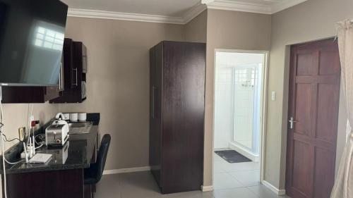 a kitchen with a counter and a cabinet and a door at 110 Berry Street Self-Catering Accommodation in Queenstown