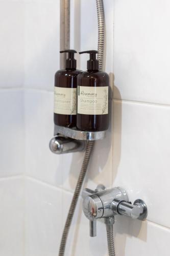 a soap dispenser in a bathroom with a shower at Movie House Executive Suite - Secure Free Parking in Belfast