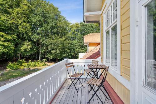 a balcony with two chairs and a table at STF Villa Söderåsen B&B in Röstånga