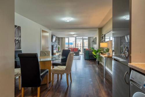 a kitchen and living room with a table and chairs at Movie House Executive Suite - Secure Free Parking in Belfast