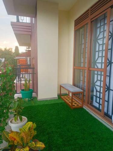 a balcony with a bench on the side of a house at Serene Homes 01 in Kampala