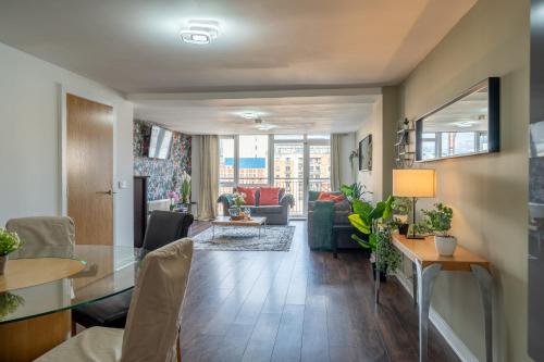 a living room with a couch and a table at Movie House Executive Suite - Secure Free Parking in Belfast