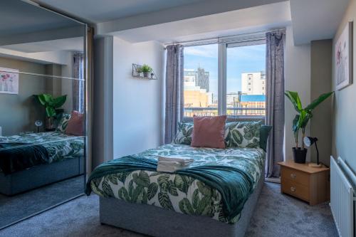 a bedroom with a bed and a large window at Movie House Executive Suite - Secure Free Parking in Belfast
