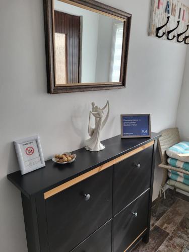 a dresser with a mirror and a plate of food on it at Charming house "Luisi" in Maribor - bike-friendly in Maribor