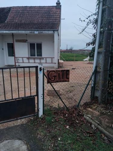 a gate with a sign in front of a house at Gîte la tourterelle in Rancy
