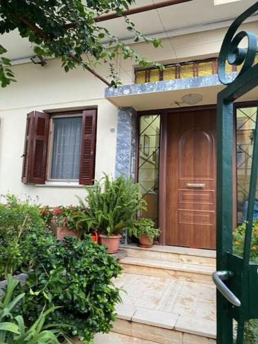 a front door of a house with potted plants at Sandras apartment in Igoumenitsa