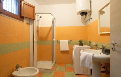 a bathroom with a shower and a toilet and a sink at Villa Oasi in San Vito lo Capo