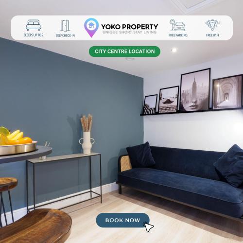 a living room with a blue couch and a shelf at Boutique Apartment - City Centre - Free Parking, Fast Wifi and Smart TV by Yoko Property in Rugby