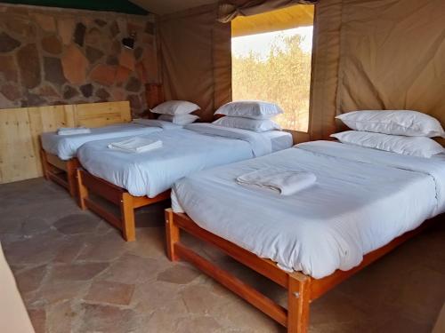 Postel nebo postele na pokoji v ubytování Resian Mara Camp