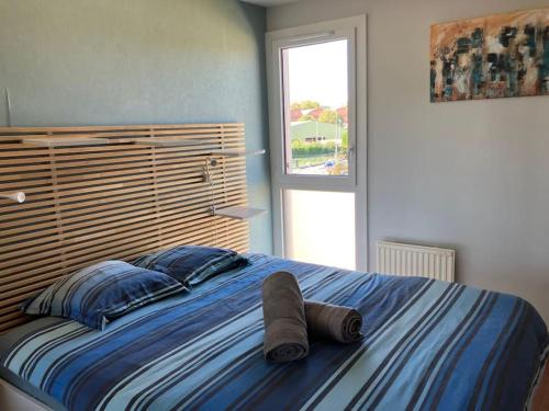 une chambre avec un grand lit avec une tête de lit en bois dans l'établissement Appartement Barrière de Paris-Ponts jumeaux, à Toulouse