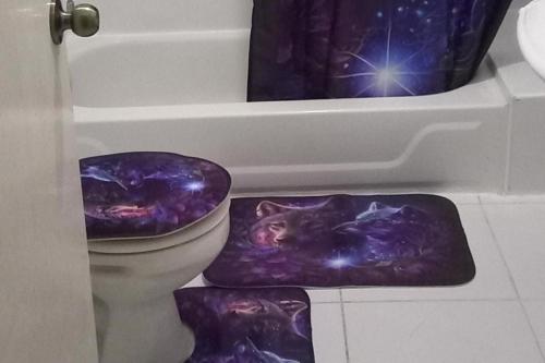 a bathroom with a toilet with a space themed floor mat at Lovely 2 Bedroom House in St Thomas Jamaica in Belfast