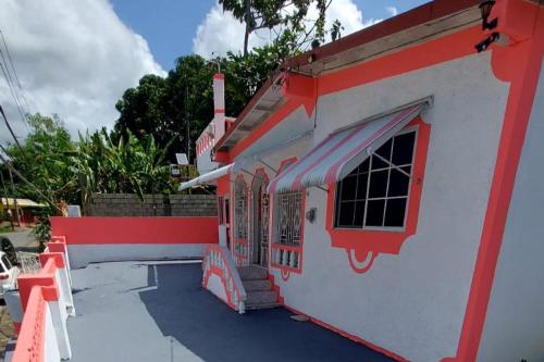 a small house with a red and white facade at Lovely 2 Bedroom House in St Thomas Jamaica in Belfast