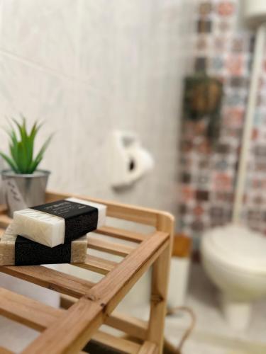 a bathroom with a bench with a sink and a toilet at Forrest Guesthouse in Polídhroson