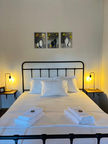 a bedroom with a bed with two towels on it at Forrest Guesthouse in Polídhroson