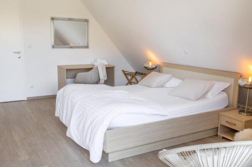 a bedroom with a large white bed and a mirror at Apartment Rosemary in Topolšica