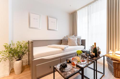 a bedroom with a bed and a table with drinks on it at Sangenjaya Modern Stay in Tokyo