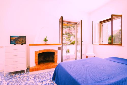 a bedroom with a bed and a fireplace at Villa Carrino Twin in Positano