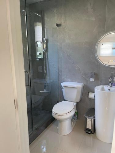 a bathroom with a toilet and a shower and a sink at Studio close to airport in Dania Beach