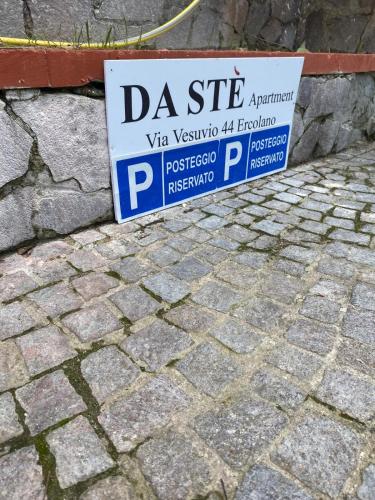 a sign sitting on the side of a brick sidewalk at Da Ste in Ercolano
