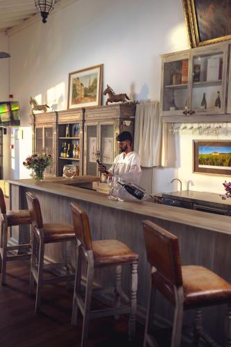 a man standing behind a bar in a restaurant at La Maison de Colombo in Colombo