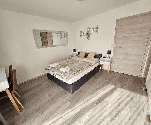 a bedroom with a large bed and a wooden floor at Sunny room 1 in Dinkelsbühl