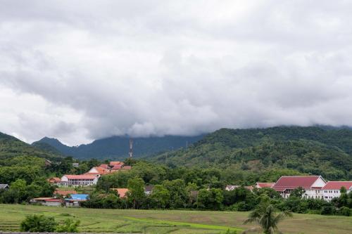 a town in front of a mountain at Garden House Rice Field and Mountain View in Luang Prabang