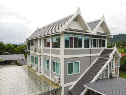 an aerial view of a house with a roof at Garden House Rice Field and Mountain View in Luang Prabang