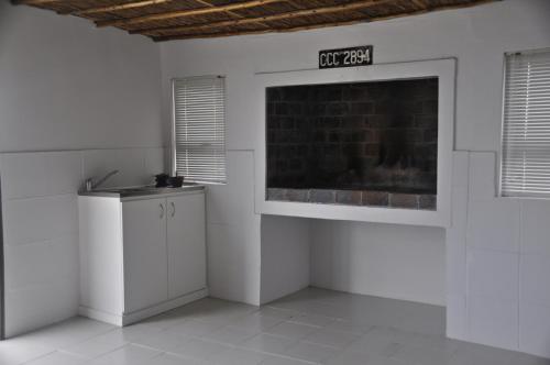 a white room with a sink and a brick wall at Grootfontein Farm accommodation in Stilbaai
