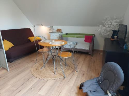 a living room with a table and a couch at Chez Manon et Martin - Chambre à la campagne avec Spa extérieur in Saâcy-sur-Marne
