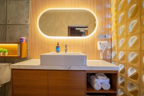 a bathroom with a sink and a mirror at Munduk Kupang Sekumpul Villa in Singaraja