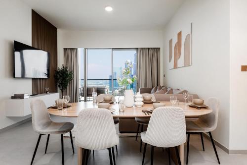 a dining room with a table and chairs at Prime Burj Khalifa&Fountain Views 2 Bdr Apartment in Dubai