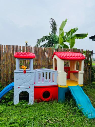 a toy train on a playground with a slide at ริมยมรีสอร์ท in Ban Wang Din