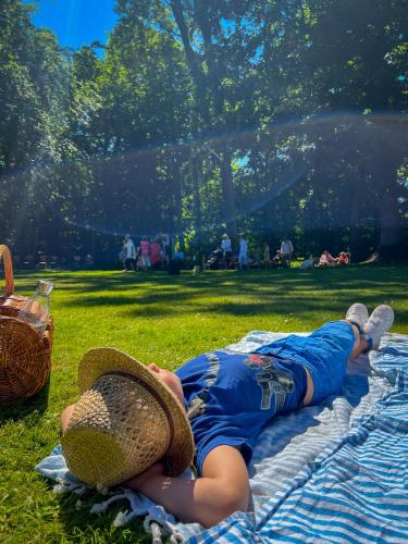a man laying on a blanket on the grass at Villa Hav & Hygge in Borrby