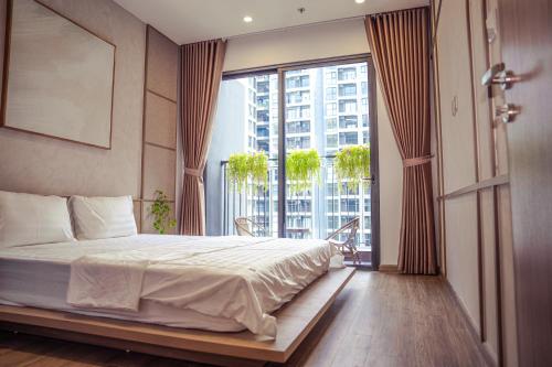 a bedroom with a bed and a large window at Chillab Homestay in Gia Lâm Pho