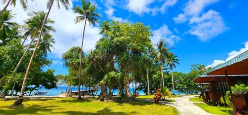 a view of the ocean from a resort with palm trees at Raflow Resort Raja Ampat in Tapokreng