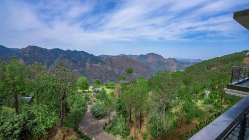 a view of the mountains from a balcony at The Manor Luxury Apartments, Shimla in Mashobra